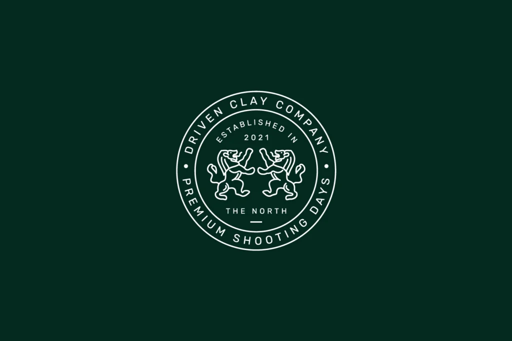 Driven Clay Co. circular crest badge with two rampant lions, 'Established in 2021' and 'The North', in white on forest green