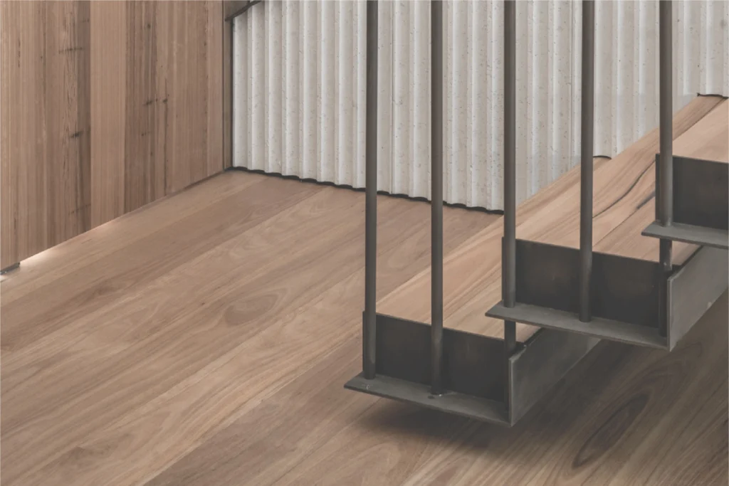 Williams Joinery photography: timber stair treads hung on dark steel rods above a wide-board wooden floor