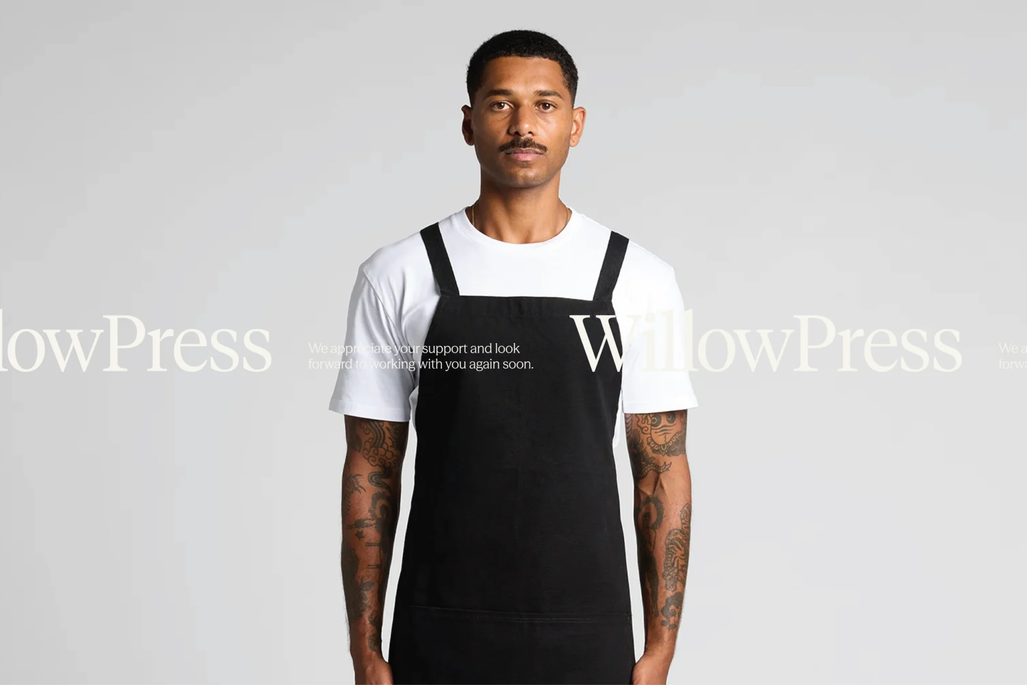 WillowPress apron campaign: model in a black apron and white T-shirt on grey, with the wordmark and a thank-you line